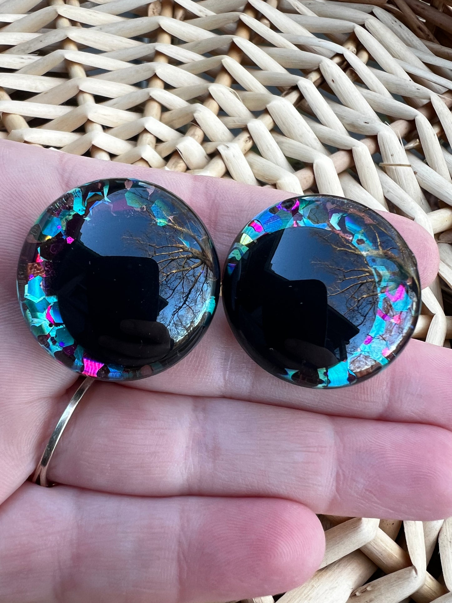 Hand painted safety eyes that feature large kawaii style black pupils with a vibrant shimmery jewel toned iris with purple, pink, and blue glitter throughout. Eyes are for crochet and knit amigurumi 