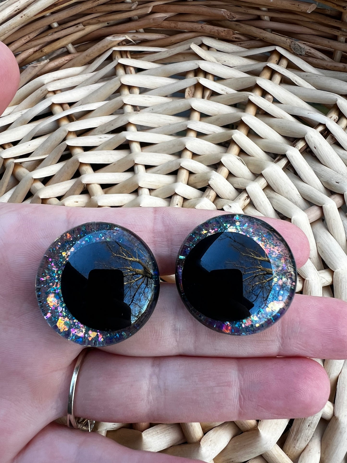 Hand painted safety eyes that feature large kawaii style black pupils and a vibrant orange, pink, and blue sparkly iridescent iris. Eyes are for crochet and knit amigurumi projects.