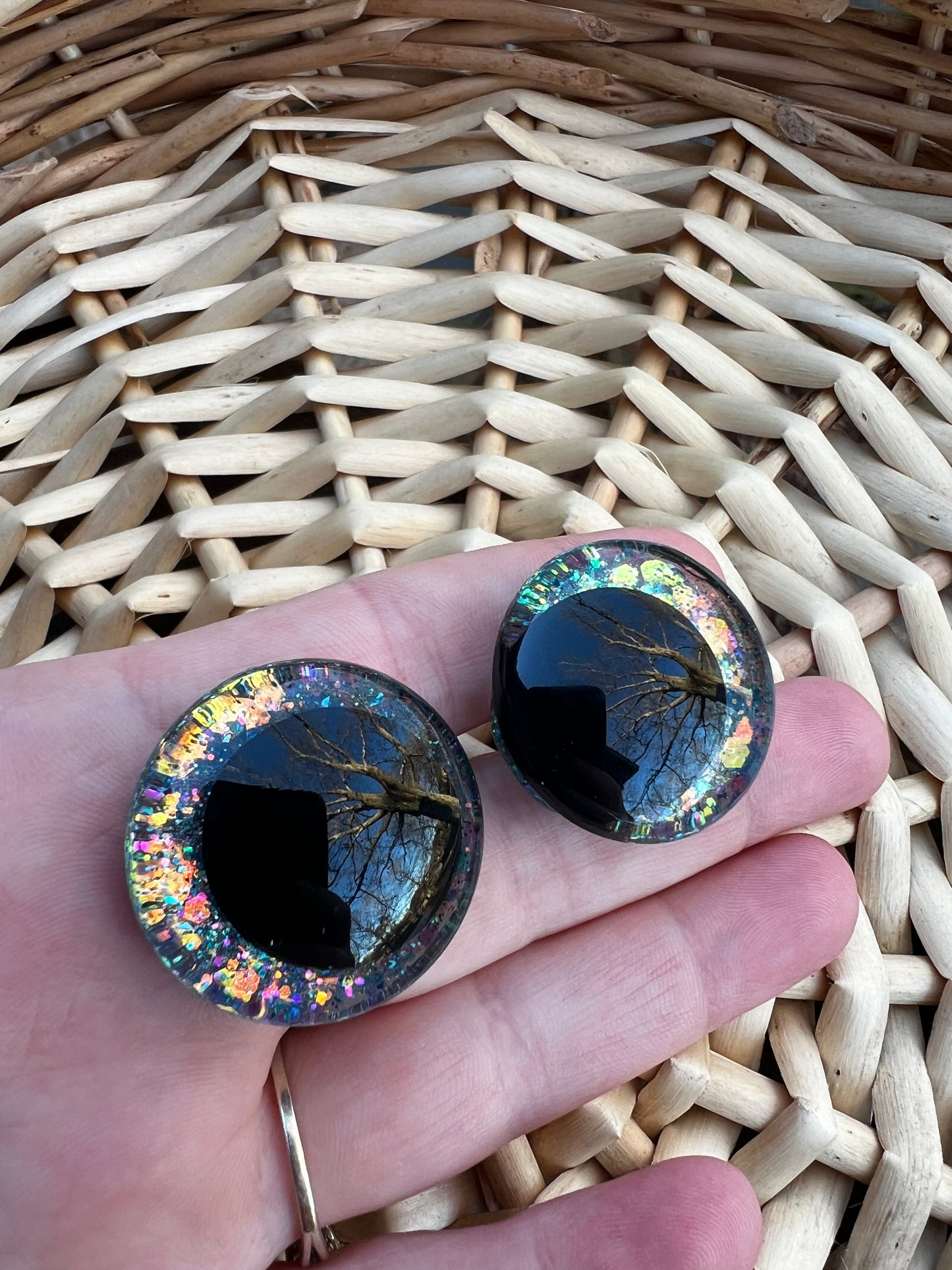 Hand painted safety eyes that feature large kawaii style black pupils and a vibrant orange, pink, and blue sparkly iridescent iris. Eyes are for crochet and knit amigurumi projects.