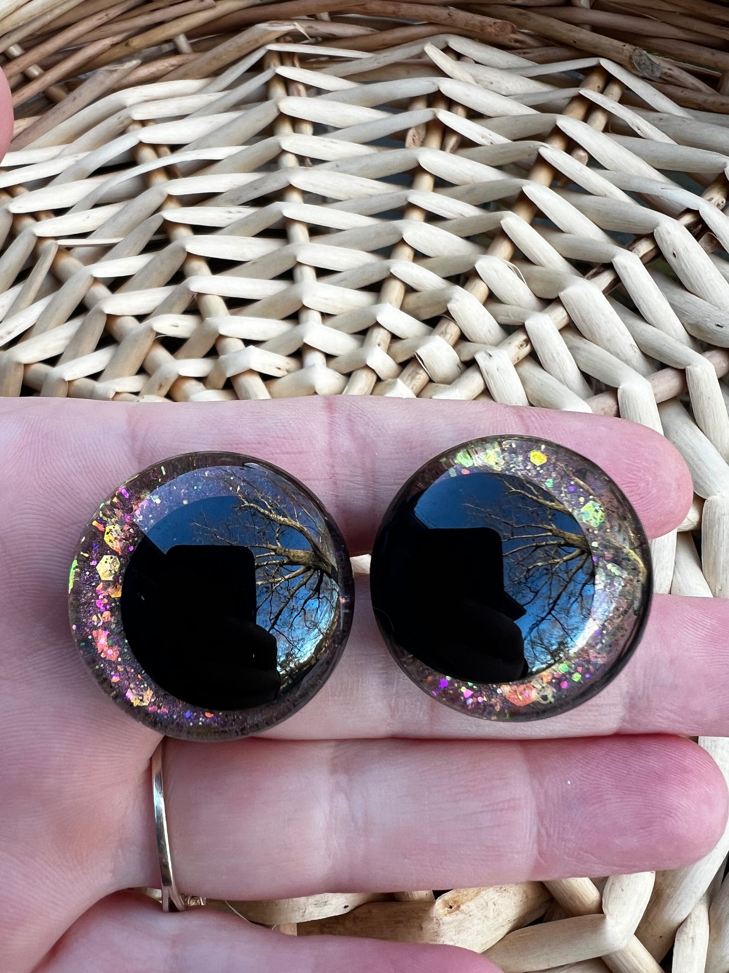 Hand painted safety eyes that feature large kawaii style black pupils and a vibrant orange, pink, and gold sparkly iridescent iris. Eyes are for crochet and knit amigurumi projects.