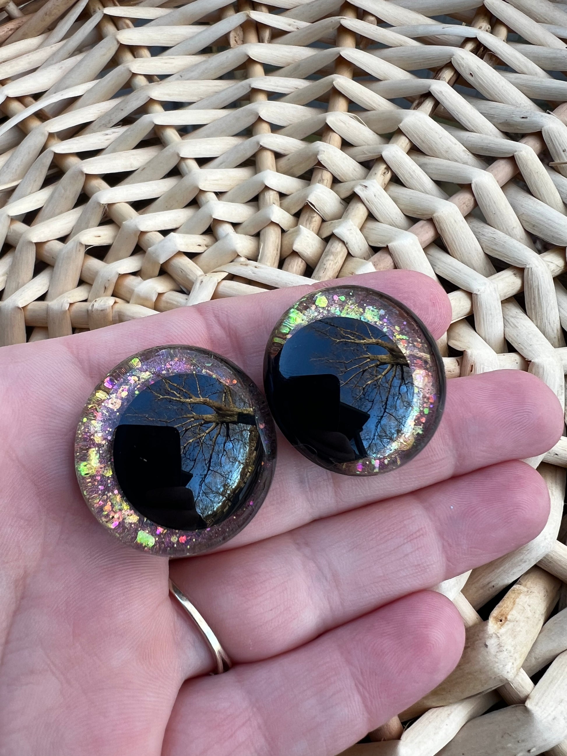 Hand painted safety eyes that feature large kawaii style black pupils and a vibrant orange, pink, and gold sparkly iridescent iris. Eyes are for crochet and knit amigurumi projects.