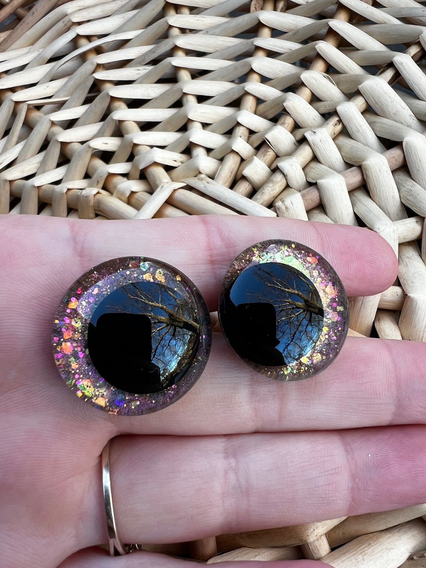 Hand painted safety eyes that feature large kawaii style black pupils and a vibrant orange, pink, and gold sparkly iridescent iris. Eyes are for crochet and knit amigurumi projects.