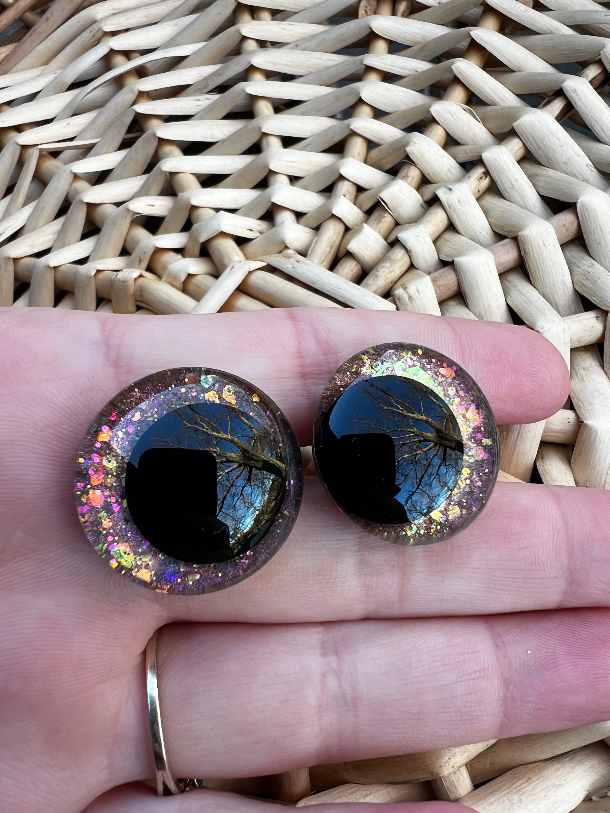 Hand painted safety eyes that feature large kawaii style black pupils and a vibrant orange, pink, and gold sparkly iridescent iris. Eyes are for crochet and knit amigurumi projects.