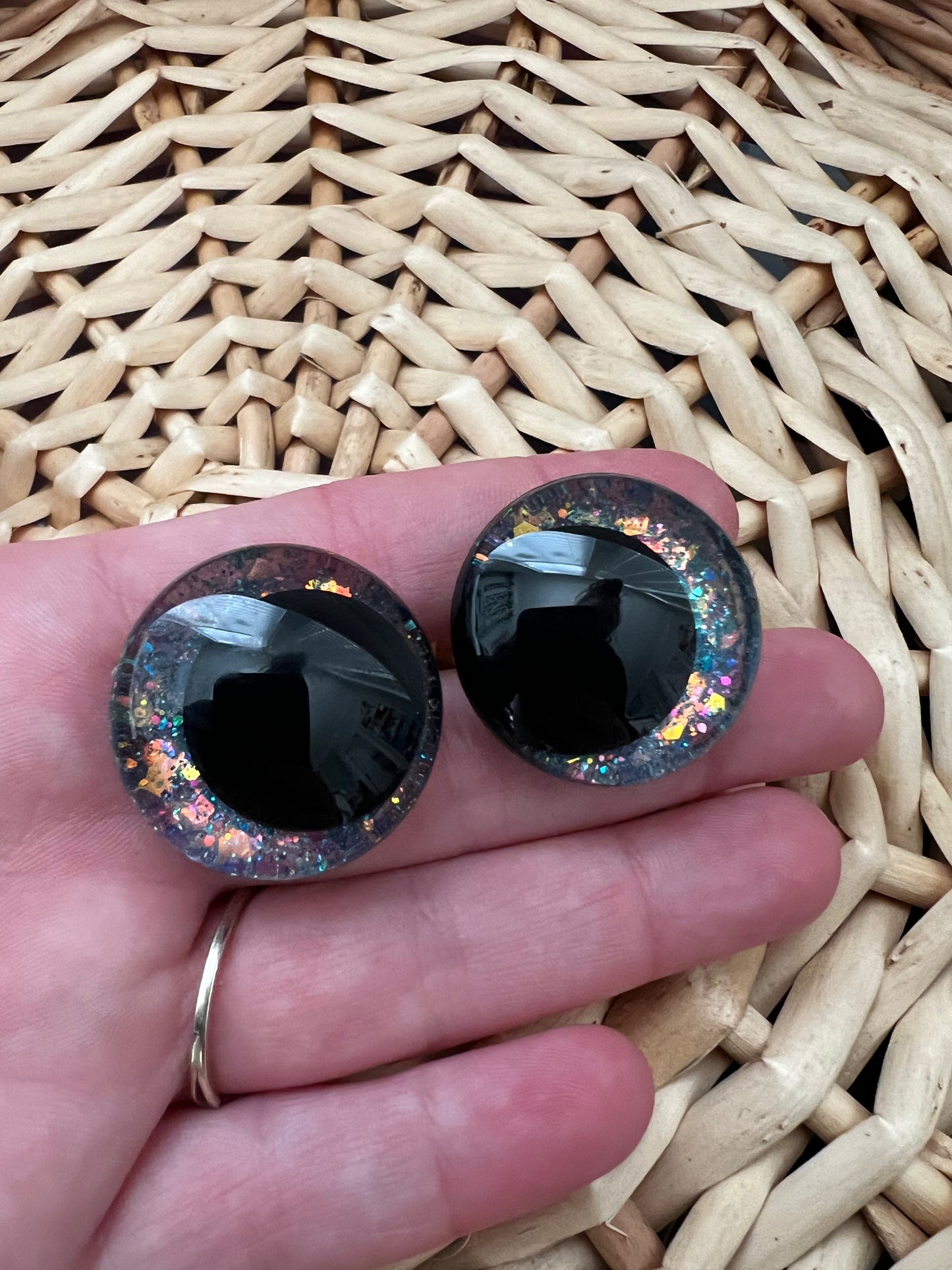 Hand painted safety eyes that feature large kawaii style black pupils and a vibrant orange, pink, and blue sparkly iridescent iris. Eyes are for crochet and knit amigurumi projects.