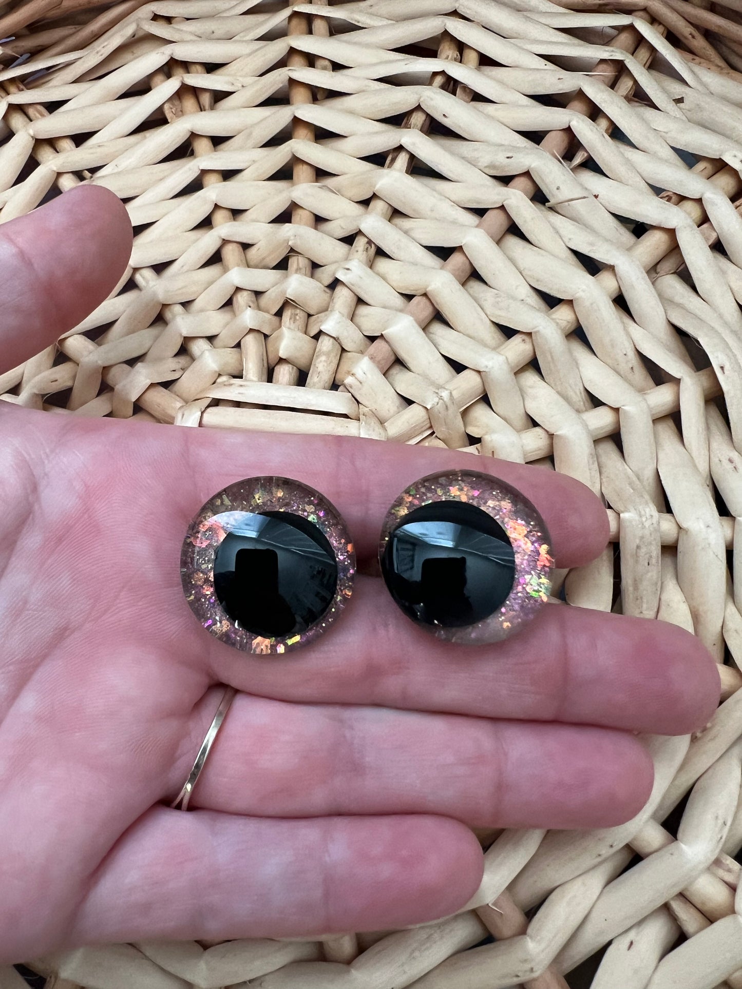 Hand painted safety eyes that feature large kawaii style black pupils and a vibrant orange, pink, and gold sparkly iridescent iris. Eyes are for crochet and knit amigurumi projects.