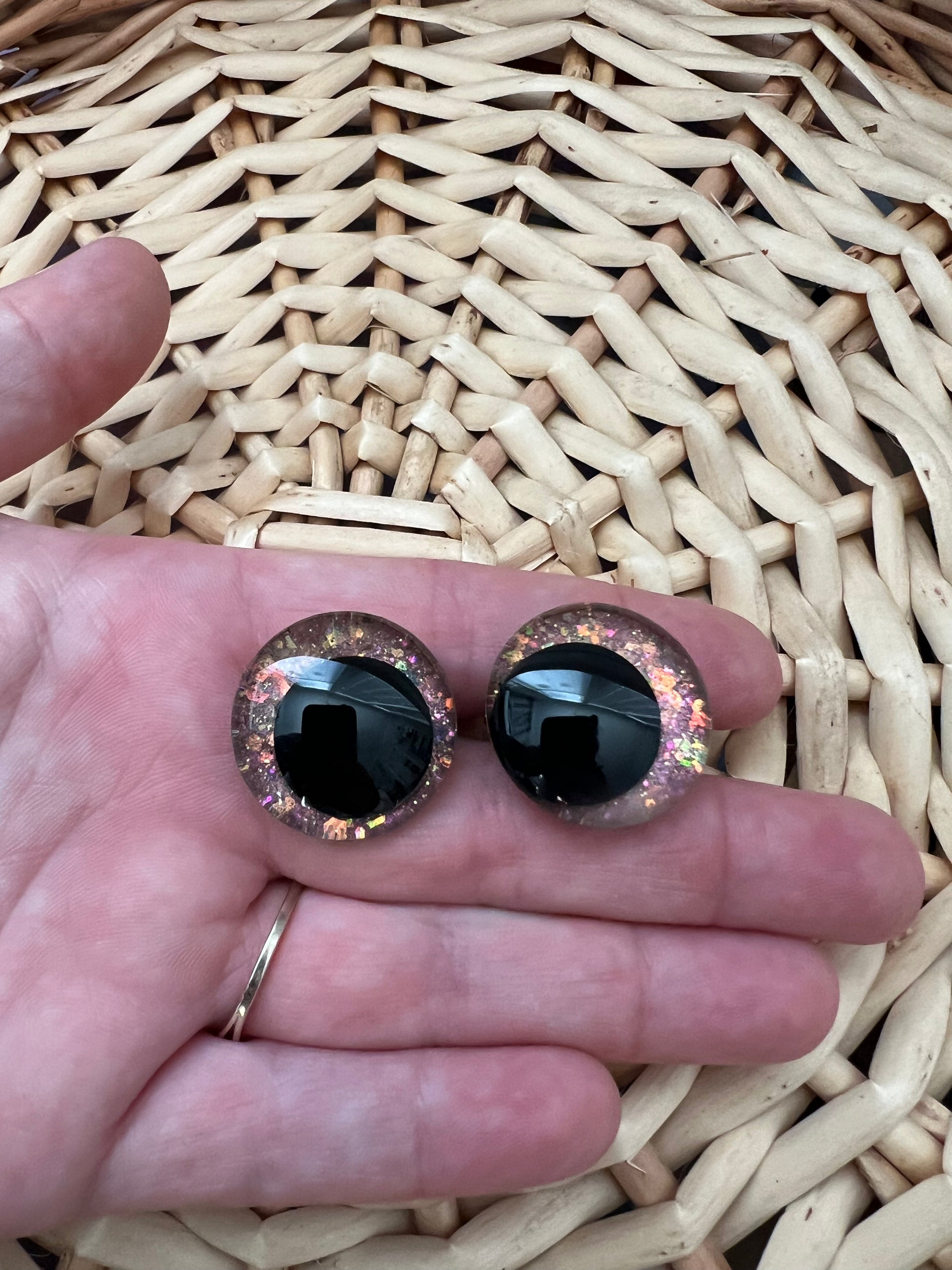 Hand painted safety eyes that feature large kawaii style black pupils and a vibrant orange, pink, and gold sparkly iridescent iris. Eyes are for crochet and knit amigurumi projects.