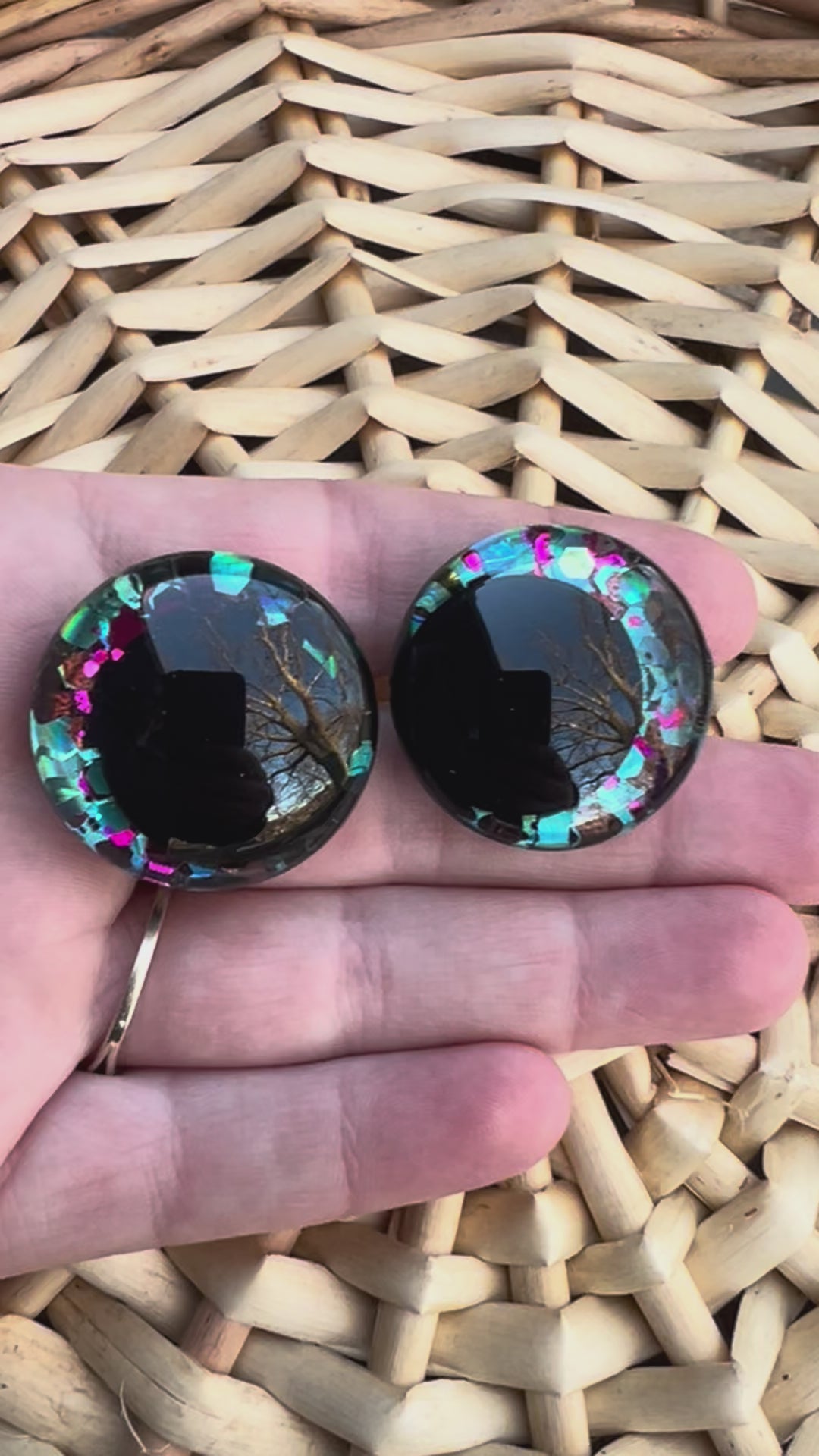 Hand painted safety eyes that feature large kawaii style black pupils with a vibrant shimmery jewel toned iris with purple, pink, and blue glitter throughout. Eyes are for crochet and knit amigurumi 