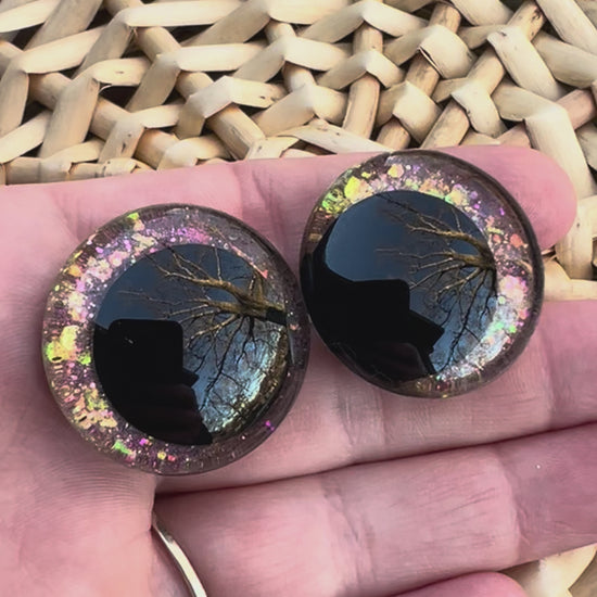 Hand painted safety eyes that feature large kawaii style black pupils and a vibrant orange, pink, and gold sparkly iridescent iris. Eyes are for crochet and knit amigurumi projects.