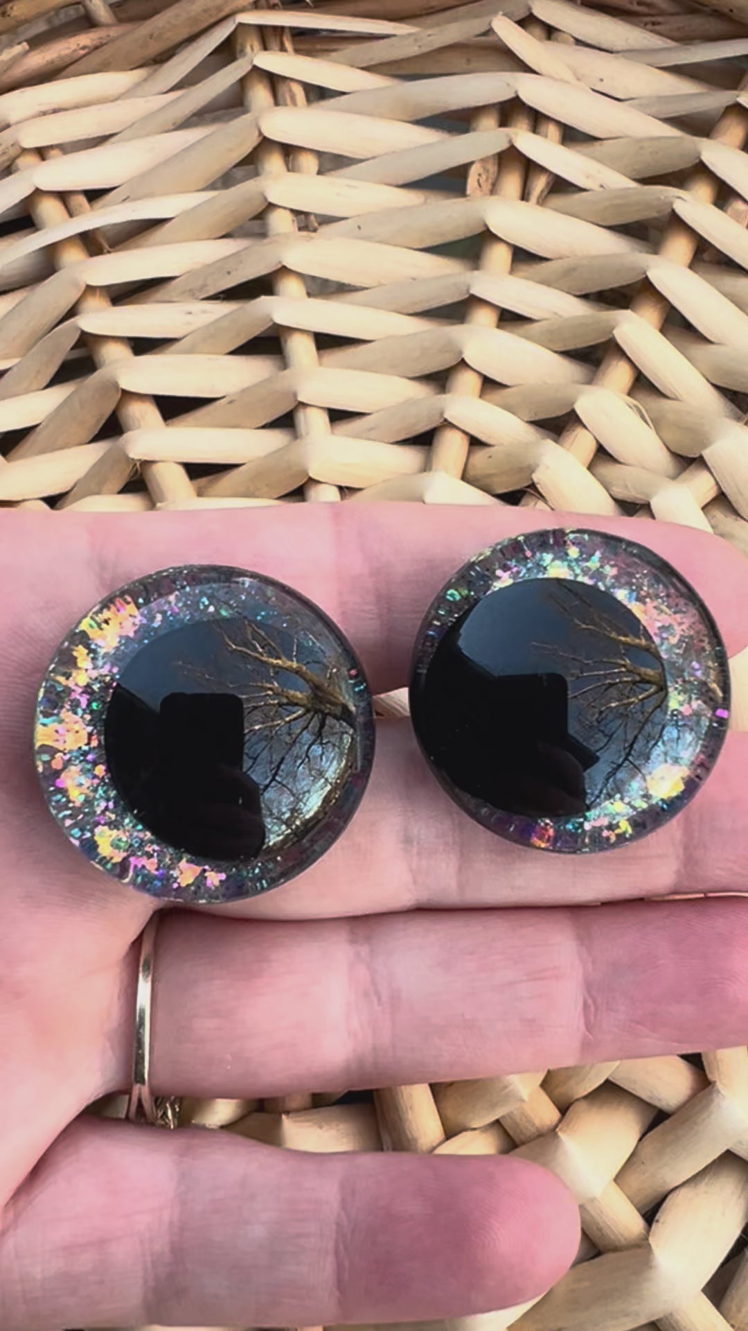 Hand painted safety eyes that feature large kawaii style black pupils and a vibrant orange, pink, and blue sparkly iridescent iris. Eyes are for crochet and knit amigurumi projects.