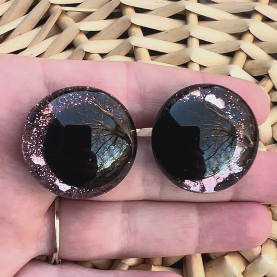 Hand painted safety eyes that feature large kawaii style black pupils with a soft pink iridescent sparkly iris. Eyes are for crochet and knit amigurumi projects.